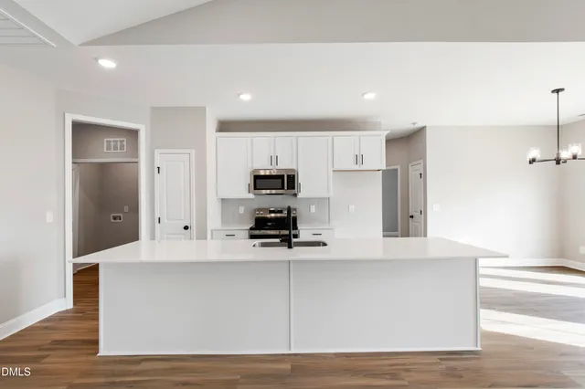 a kitchen with kitchen island a counter top and appliances