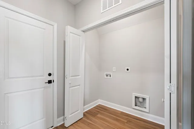 a view of a small space with wooden floor