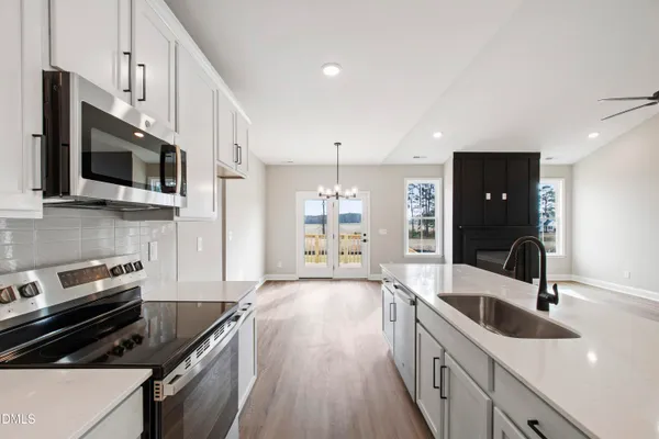 a kitchen with granite countertop a stove and a sink