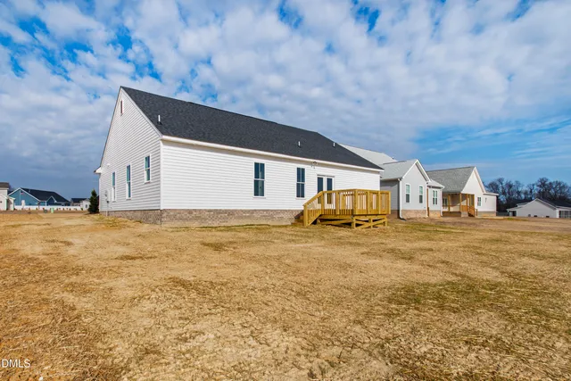 a house view with swimming pool in front of it