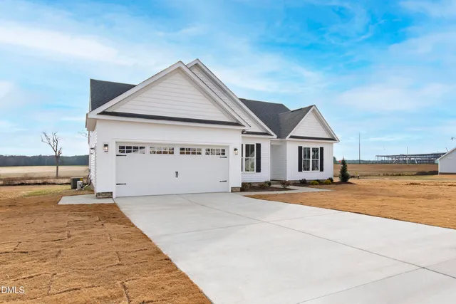 a view of a house with yard and sitting area
