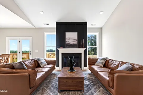 a living room with furniture and kitchen view