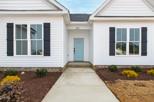a front view of a house with a rug