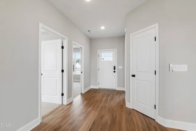 a view of a hallway with wooden floor