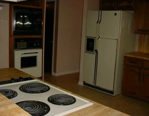 a kitchen with a stove and a refrigerator
