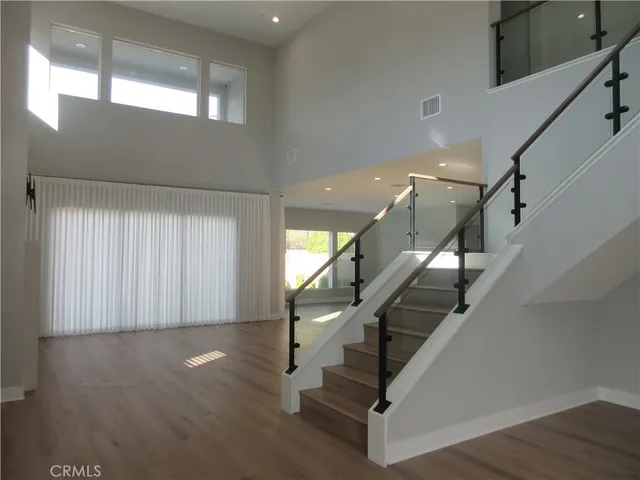 a view of entryway with wooden floor and stairs
