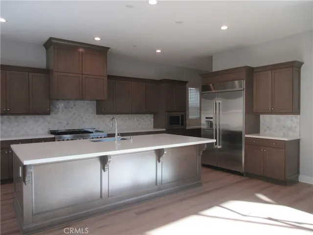 a kitchen with a sink stainless steel appliances and cabinets