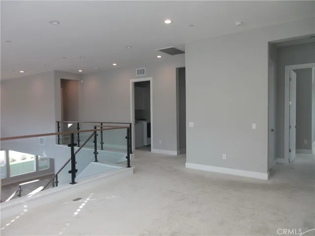 a view of a hall with wooden floor