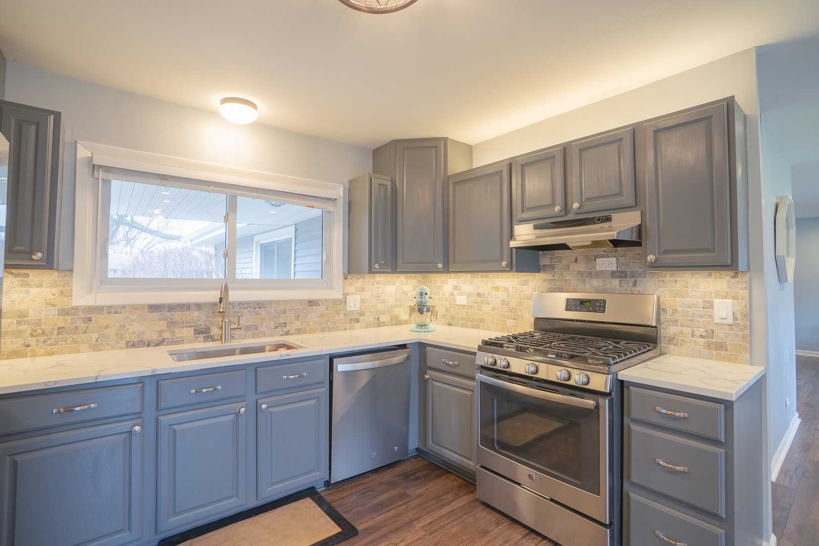 1935 Larchmont Road Hoffman Estates, IL 60169 - Photo 11 of 30 a kitchen with kitchen island granite countertop a sink cabinets and stainless steel appliances