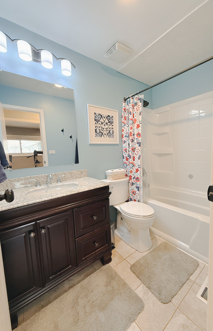 1935 Larchmont Road Hoffman Estates, IL 60169 - Photo 16 of 30 a bathroom with a sink a toilet and a bathtub