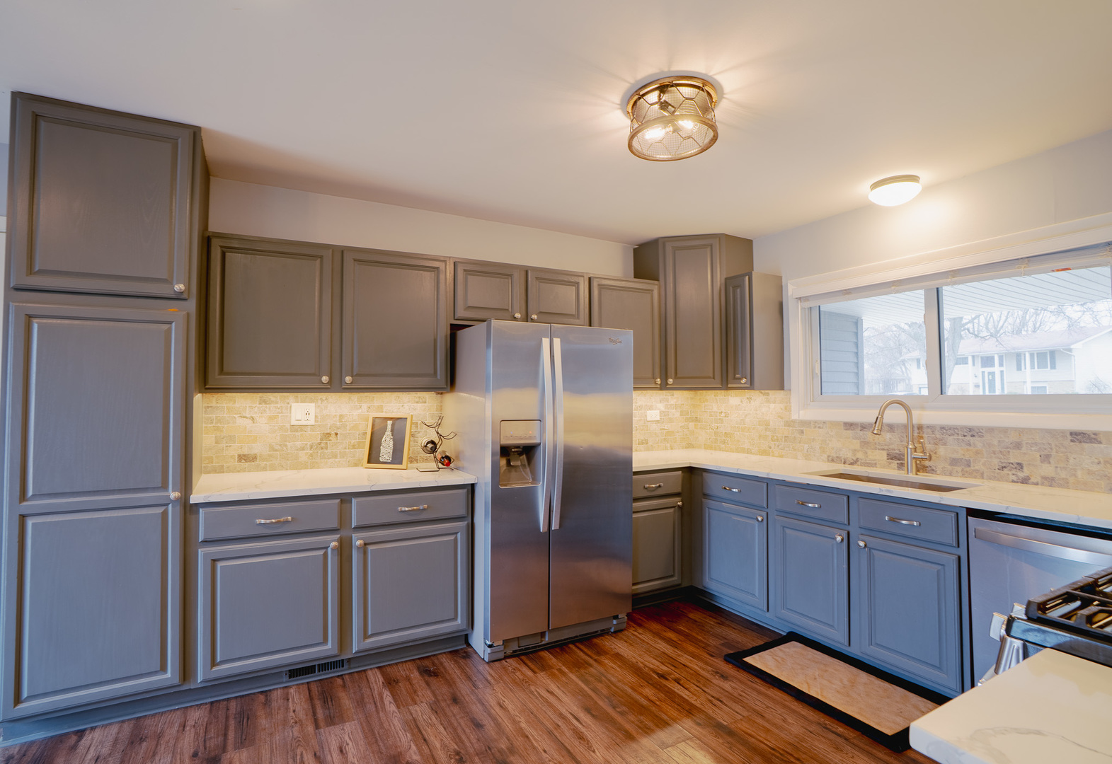 1935 Larchmont Road Hoffman Estates, IL 60169 - Photo 9 of 30 a kitchen with stainless steel appliances granite countertop a refrigerator a stove a sink and dishwasher with wooden floor