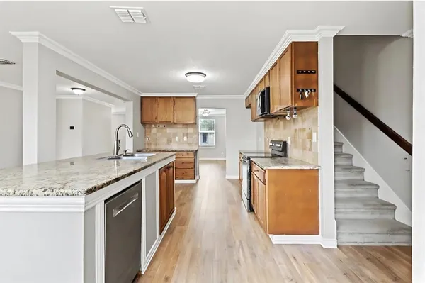 a kitchen with stainless steel appliances granite countertop a stove and a sink