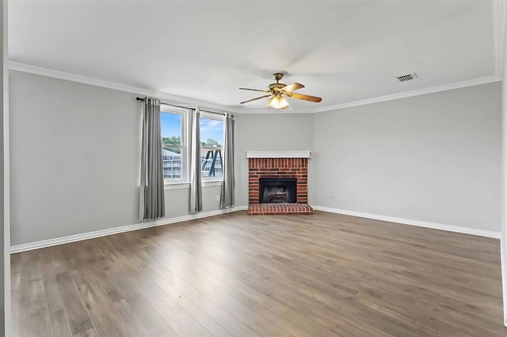 2923 Glendale Drive Wylie, TX 75098 - Photo 4 of 13 a view of an empty room with a fireplace and a window