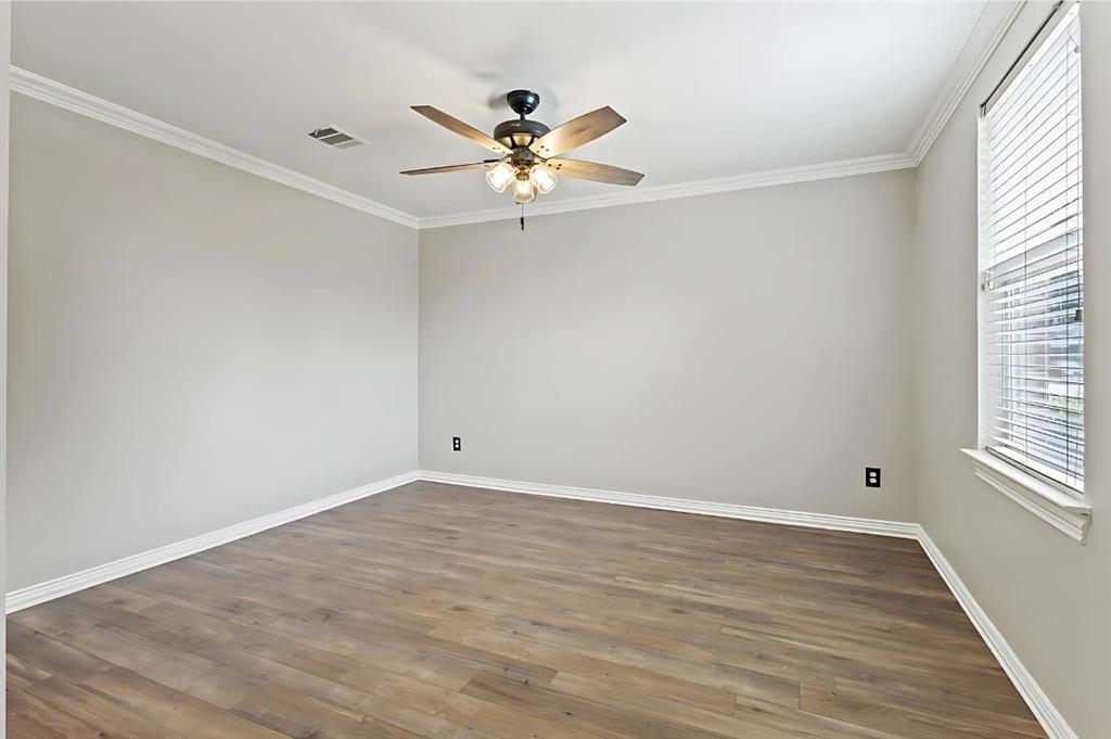 2923 Glendale Drive Wylie, TX 75098 - Photo 6 of 13 a view of an empty room with wooden floor and a window