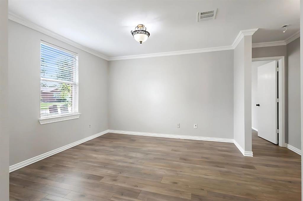 2923 Glendale Drive Wylie, TX 75098 - Photo 7 of 13 an empty room with wooden floor and windows