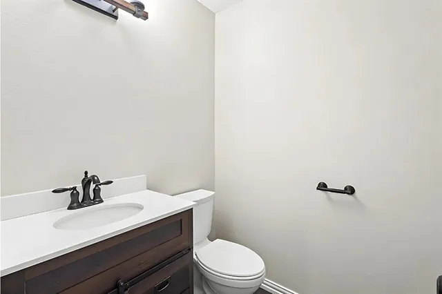 a bathroom with a sink a toilet and mirror