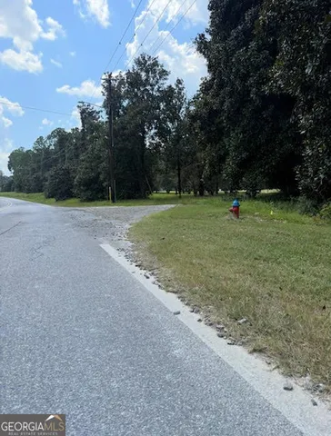 a view of outdoor space with green field and trees