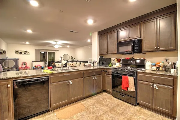 a kitchen with sink cabinets and microwave