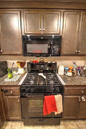 a kitchen with granite countertop a stove top oven