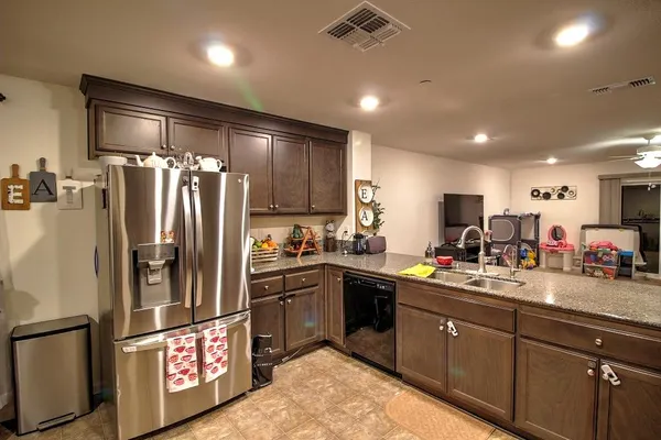 a kitchen with refrigerator and cabinets
