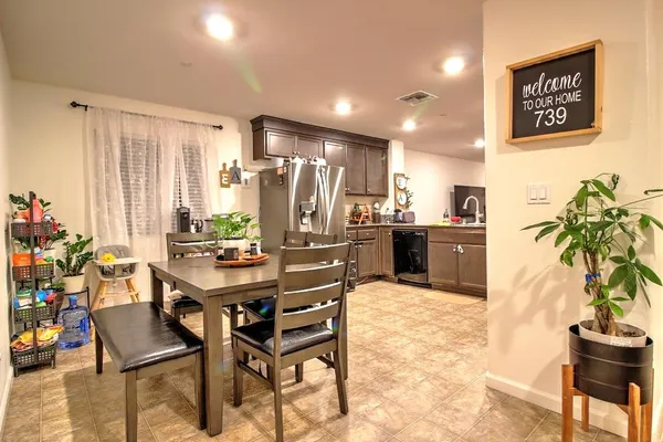 a view of a dining room with furniture and a potted plant