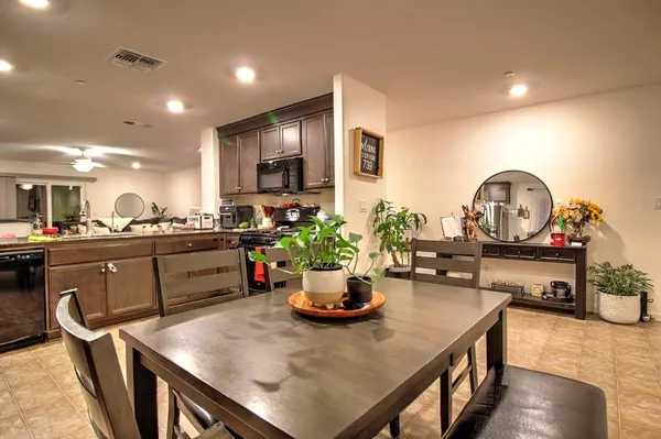 a kitchen with a table chairs stove and microwave