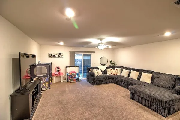 a view of a livingroom with furniture and a flat screen tv