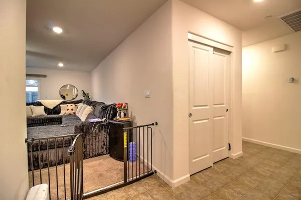 a view of a hallway with wooden shelves