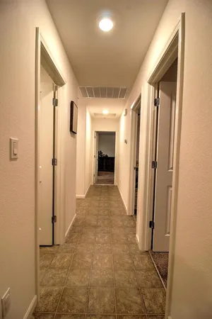 a view of a room with furniture and a window