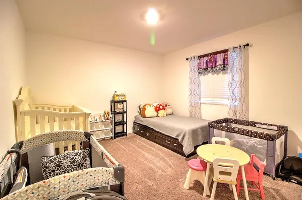 a utility room with furniture a rug and a window