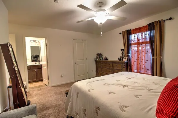 a bathroom with a sink a toilet a mirror and shower curtain