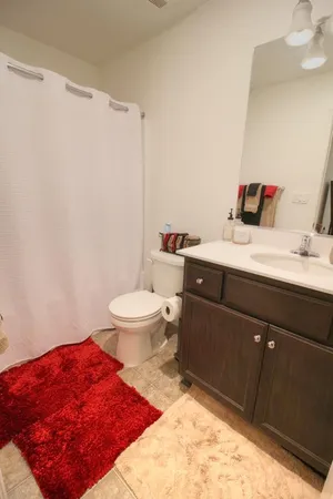 a bedroom with furniture and a rug