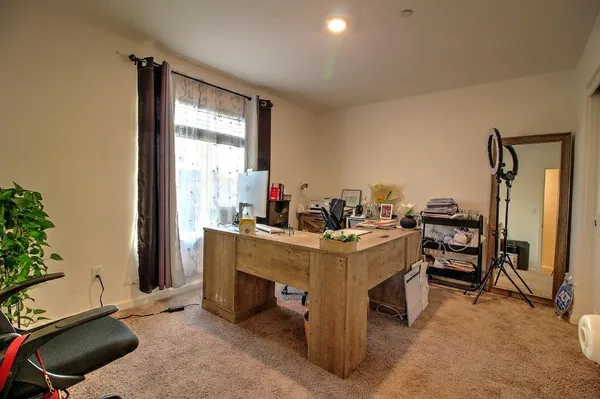 a view of a room with furniture and a window