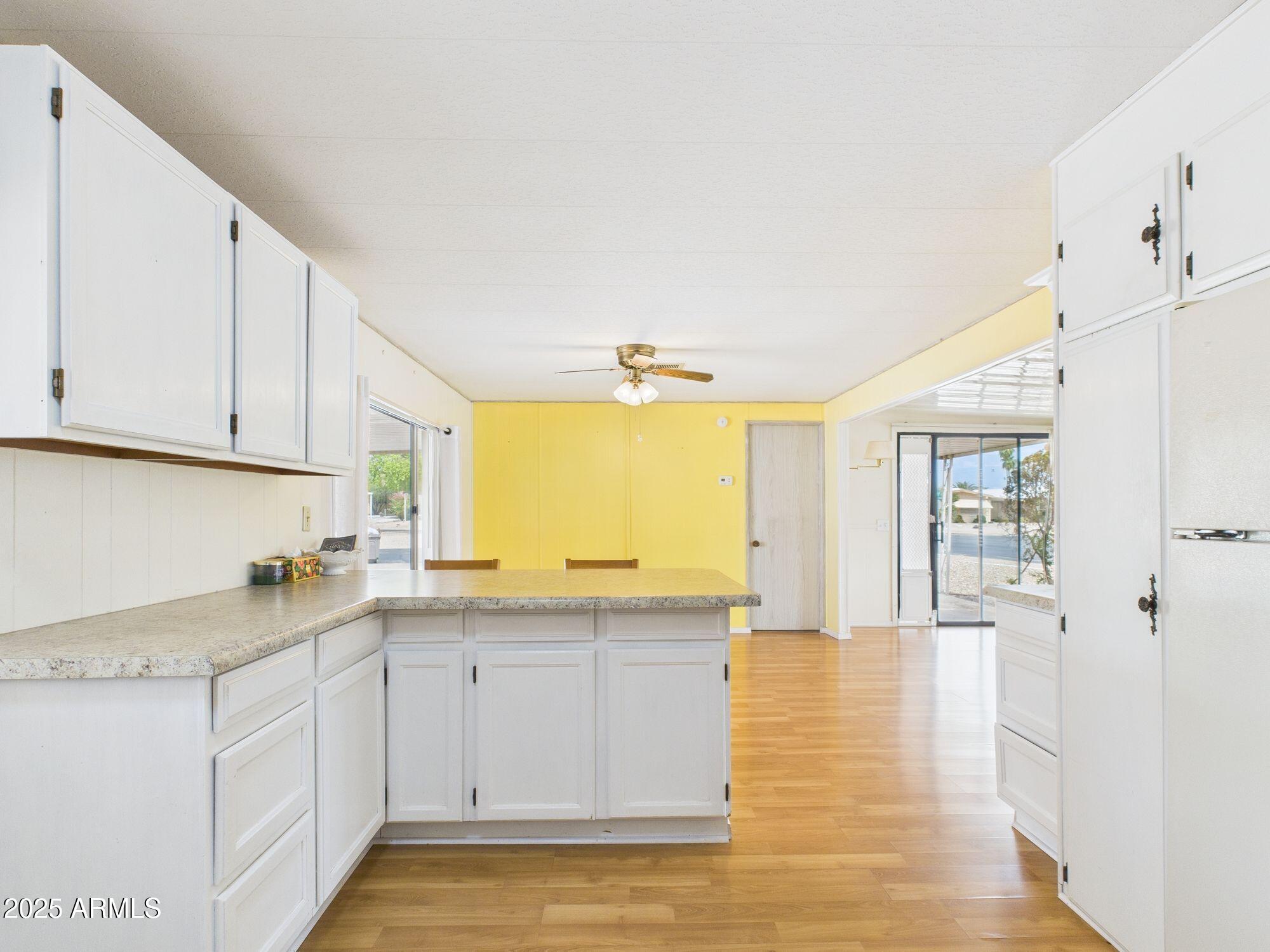 428 South 80th Way Mesa, AZ 85208 - Photo 11 of 21 a kitchen with granite countertop a sink cabinets and wooden floor