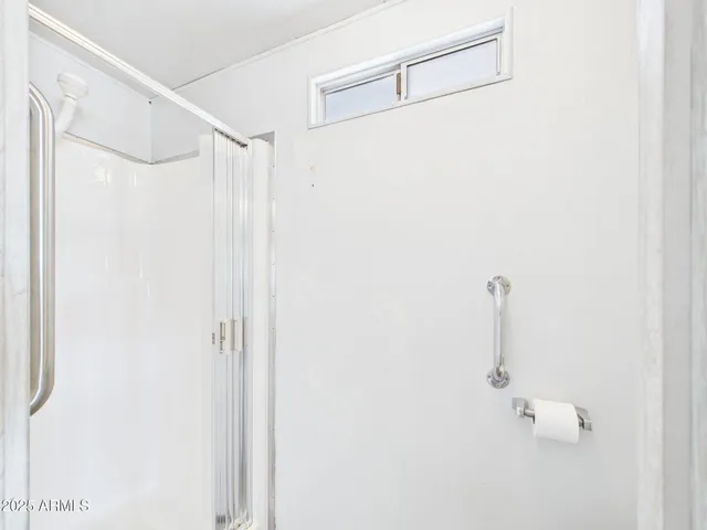 a bathroom with a shower and a shower
