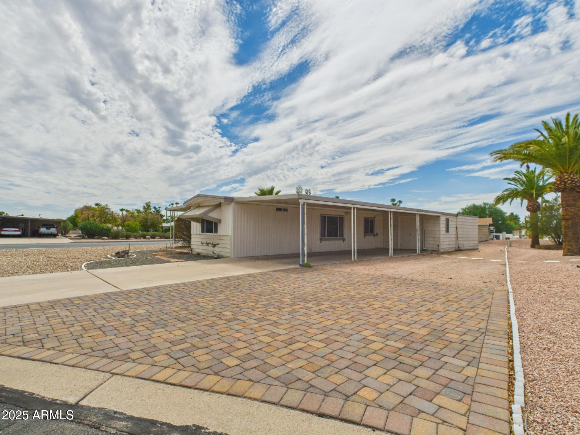 428 South 80th Way Mesa, AZ 85208 - Photo 3 of 21 a front view of a house with a yard and trees