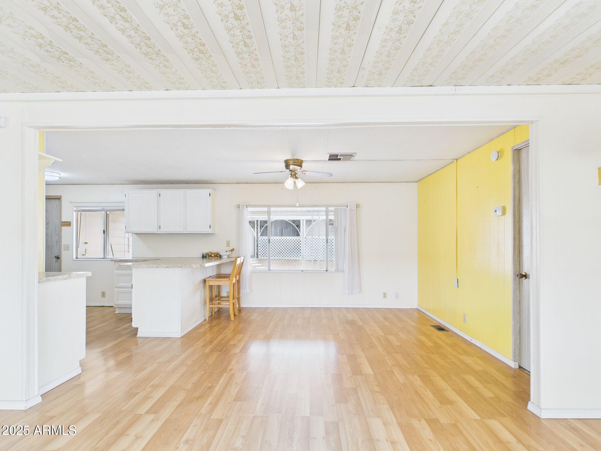 428 South 80th Way Mesa, AZ 85208 - Photo 6 of 21 a view of a kitchen with wooden floor and a window