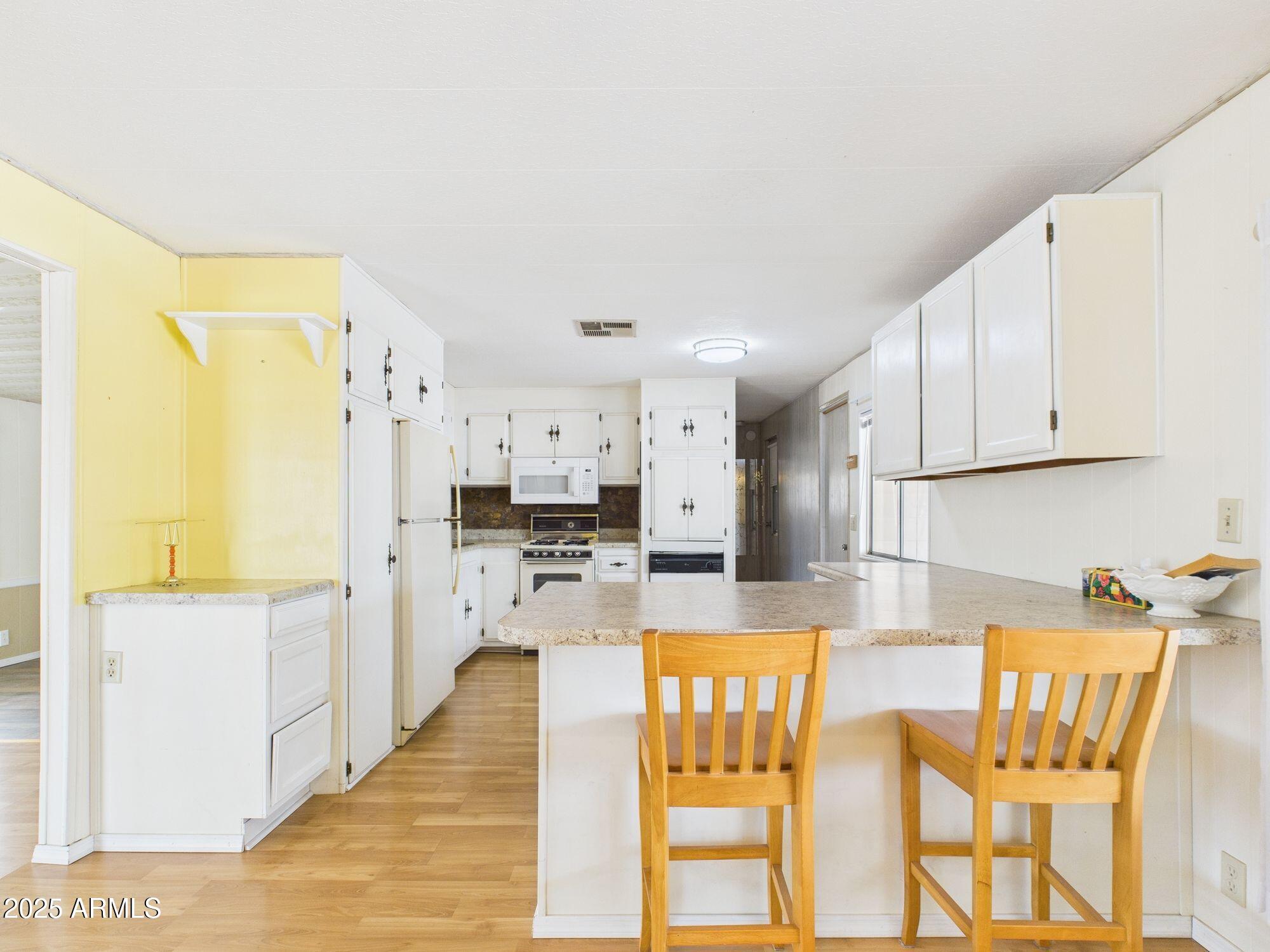 428 South 80th Way Mesa, AZ 85208 - Photo 7 of 21 a kitchen with stainless steel appliances kitchen island granite countertop a refrigerator and microwave