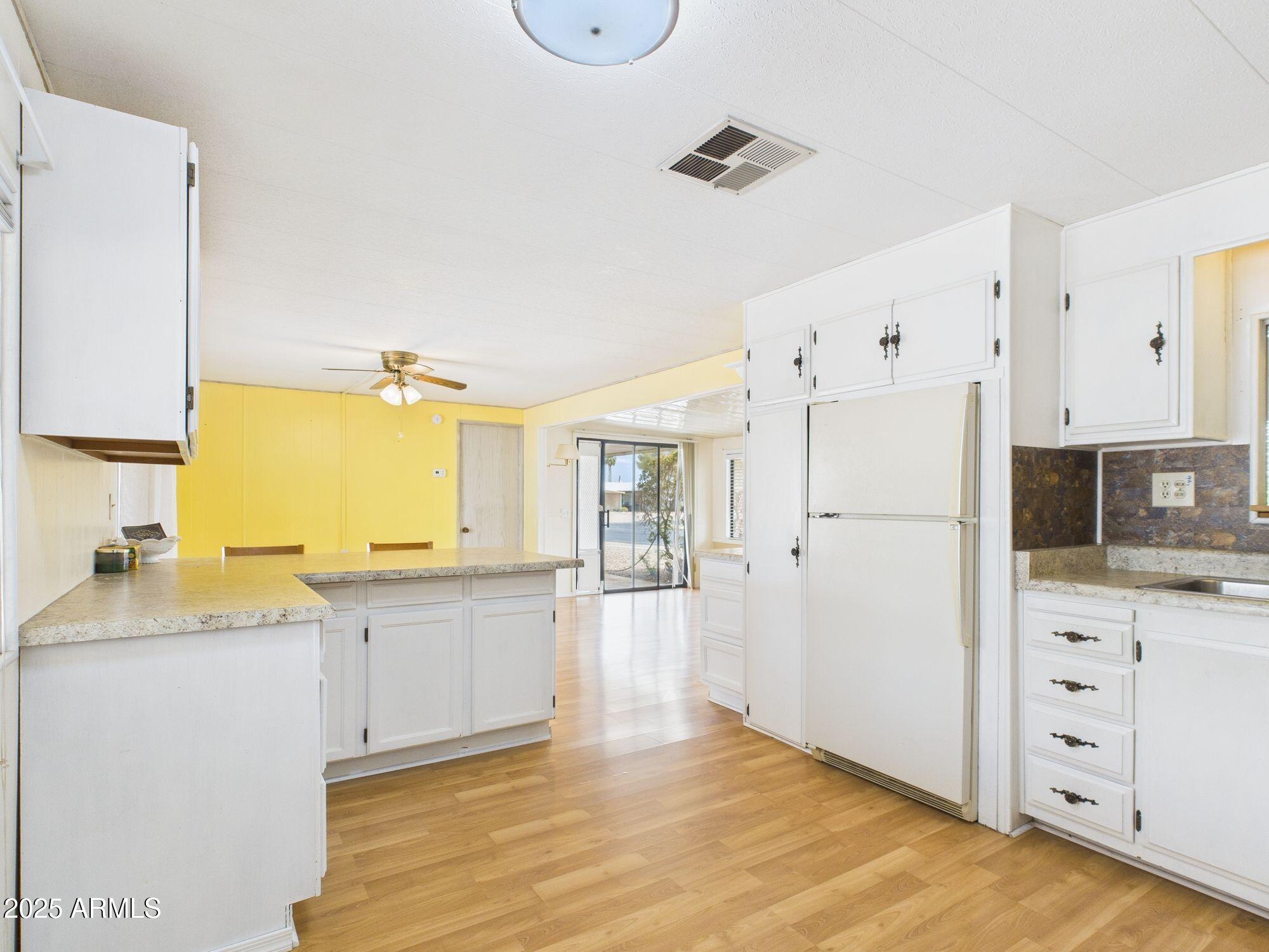 428 South 80th Way Mesa, AZ 85208 - Photo 9 of 21 a kitchen with granite countertop a sink stove and refrigerator