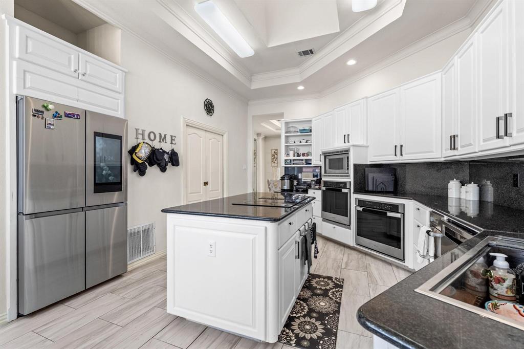 200 Mill Crossing West Colleyville, TX 76034 - Photo 13 of 40 a kitchen with granite countertop a refrigerator stove and sink