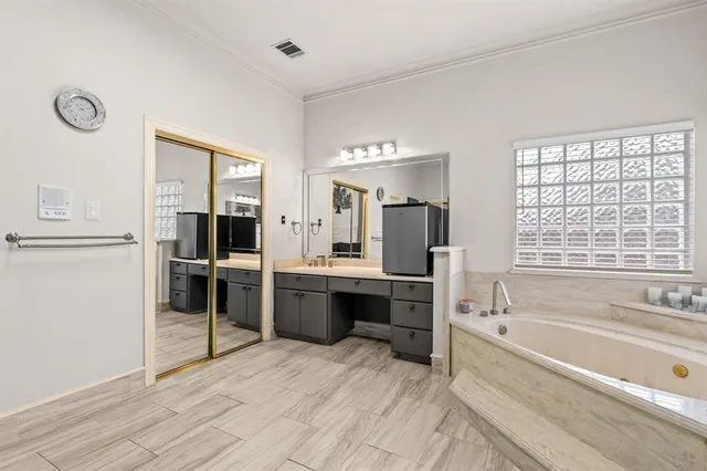 a large bathroom with a large tub and sink