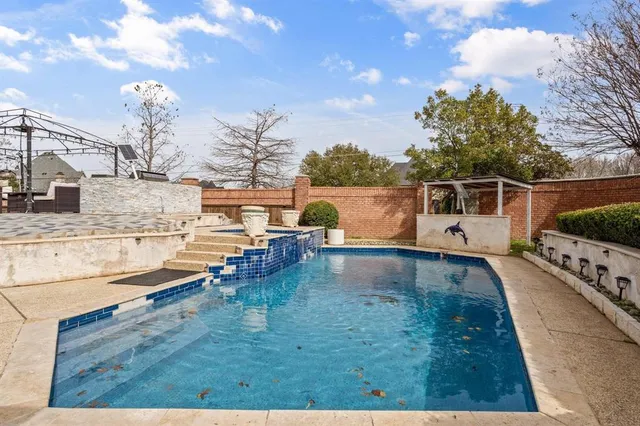 a view of a swimming pool with a yard