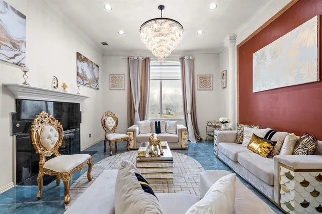 a living room with furniture chandelier and a large window