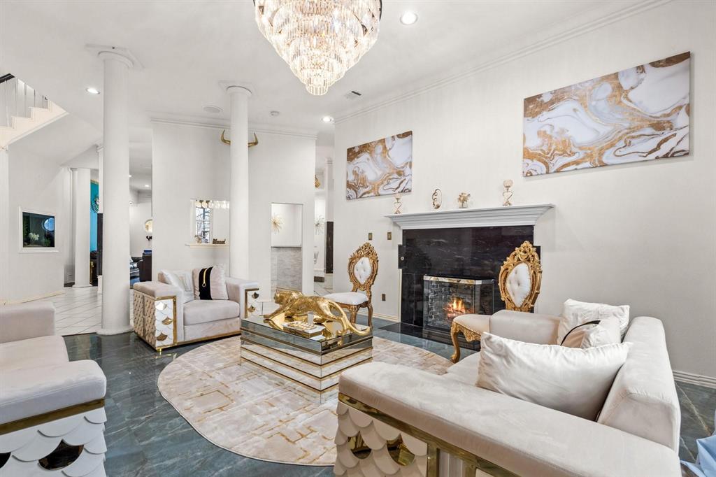 200 Mill Crossing West Colleyville, TX 76034 - Photo 7 of 40 a living room with furniture a fireplace and a chandelier