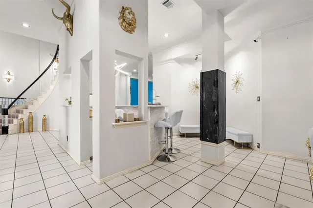 a view of kitchen with furniture and refrigerator