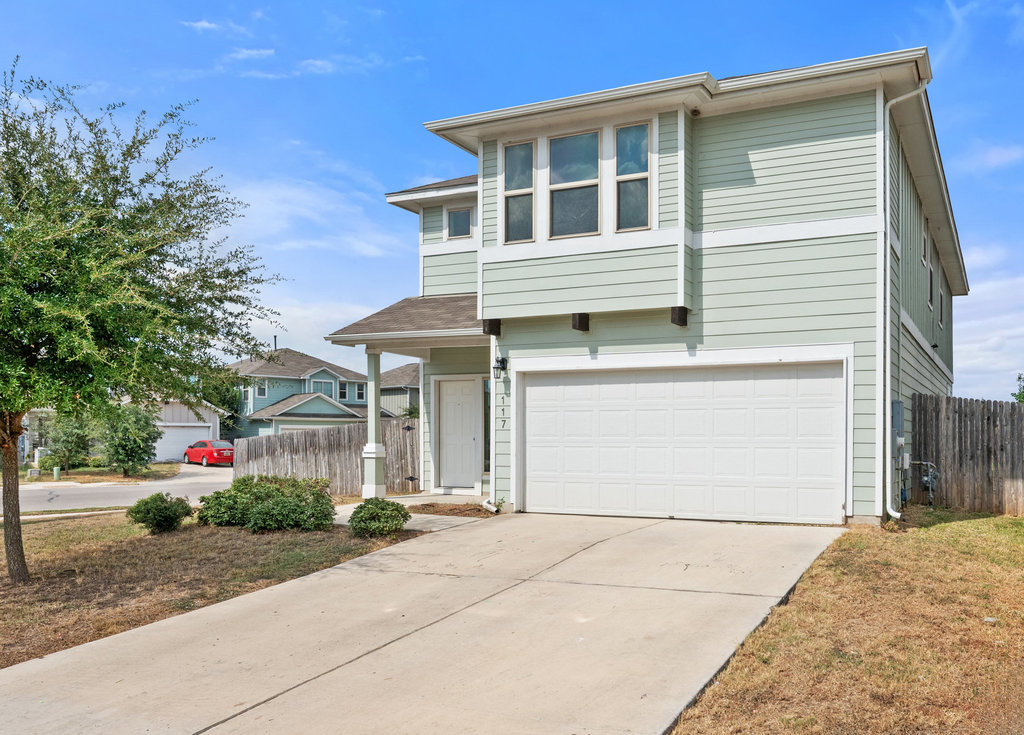 a front view of a house with a yard and garage