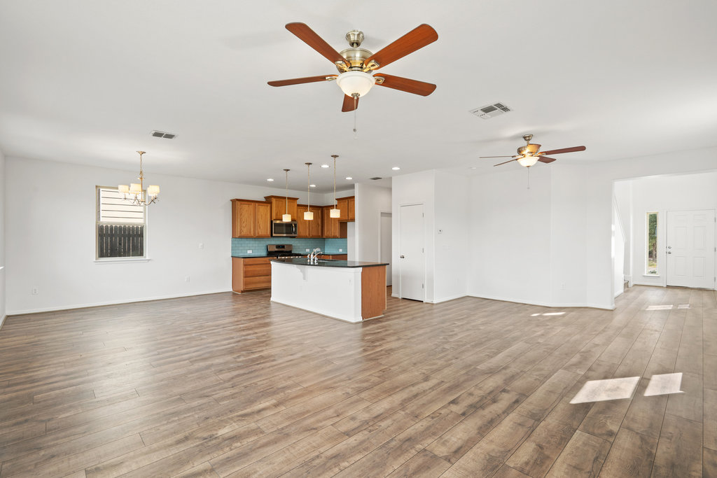 117 Wapiti Road Buda, TX 78610 - Photo 16 of 35 a view of a kitchen with microwave and a stove