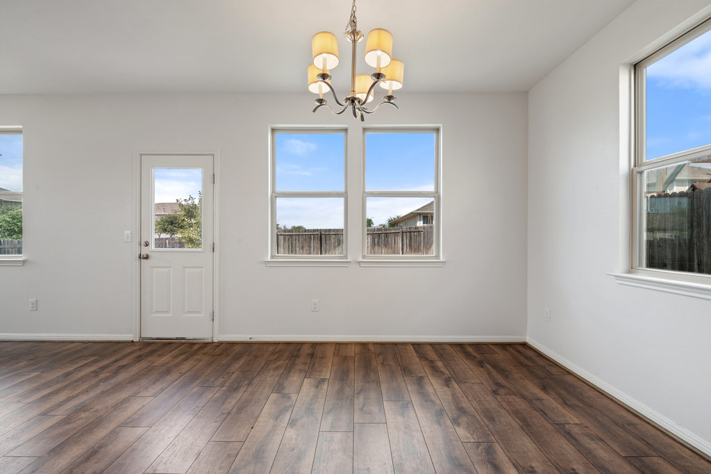 117 Wapiti Road Buda, TX 78610 - Photo 18 of 35 a view of a room with wooden floors and chandelier