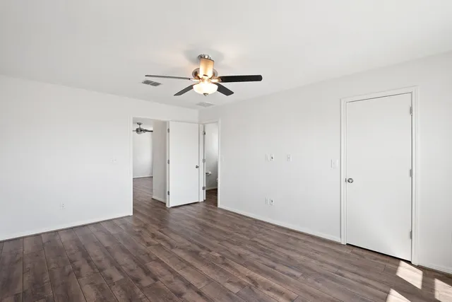 a view of a room with wooden floors and chandelier