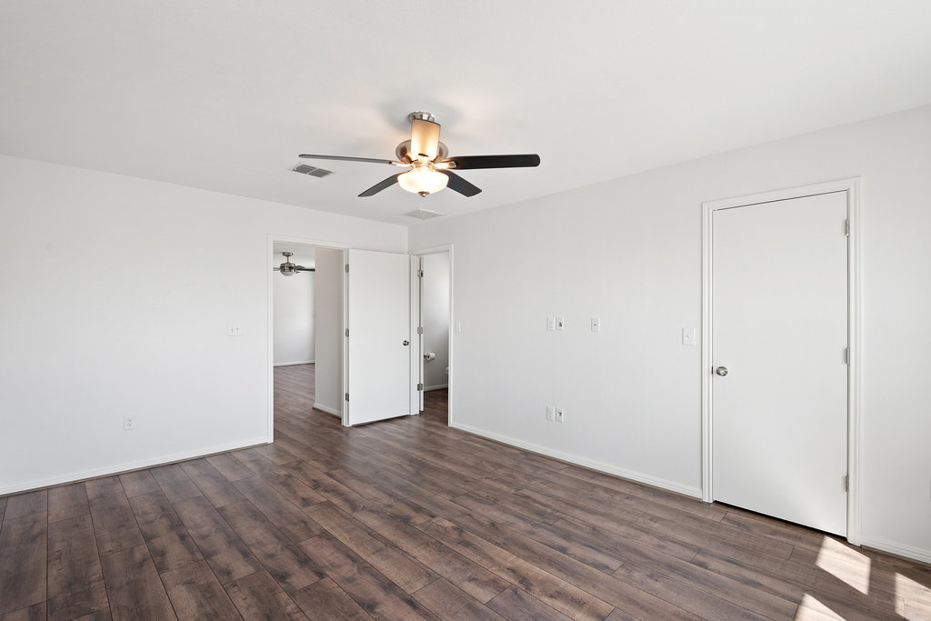 117 Wapiti Road Buda, TX 78610 - Photo 21 of 35 a view of a room with wooden floor and a ceiling fan